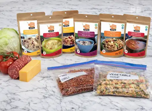 A countertop display of fresh food, freeze-dried meals, and dehydrated meals