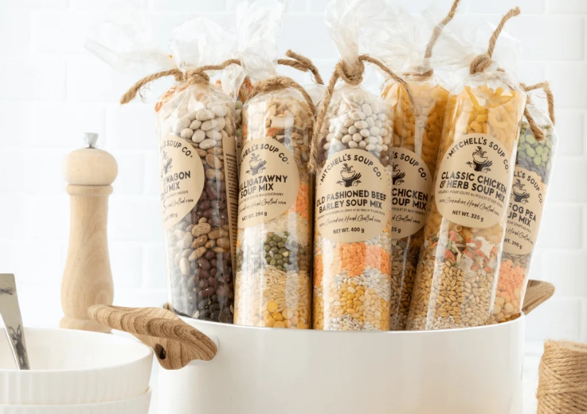 A kitchen countertop showing a pot with several soup mixes bundled