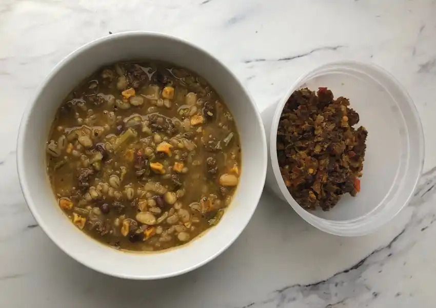 A close up of a bowl of dehydrated beef barley simmered to compare