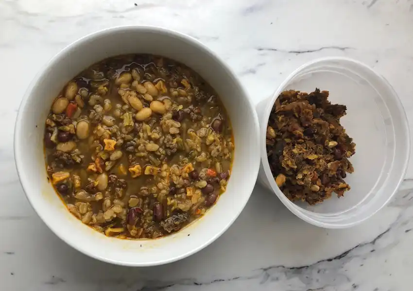A close up of a bowl of beef barley rehydrated and soaked to compare