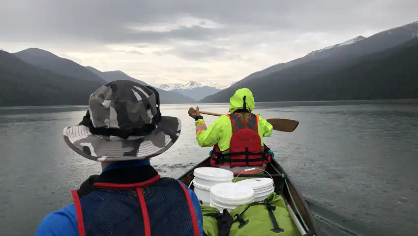 A photo of paddling the canoe filled with gear and food pails