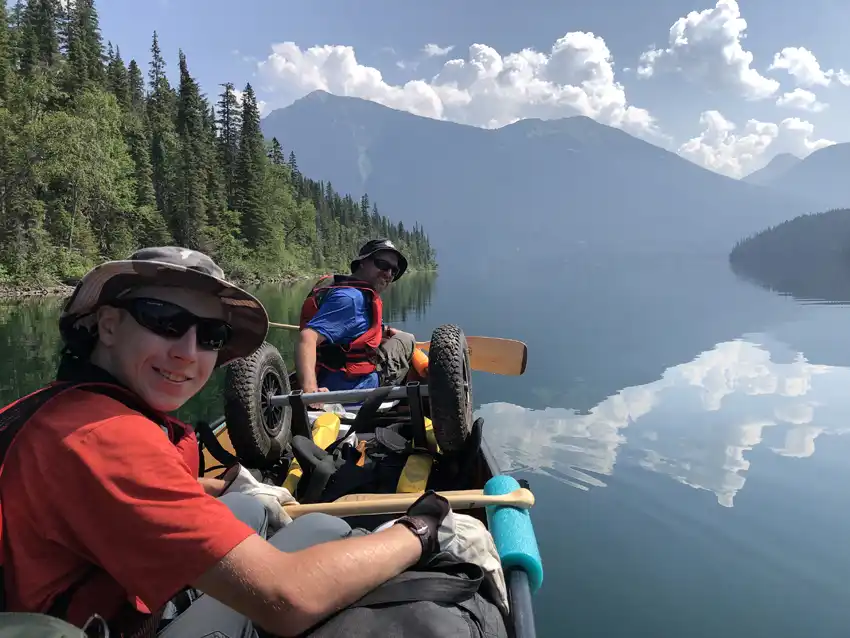 A photo of Adam and Nick while on a glassy lake and mountains in the background