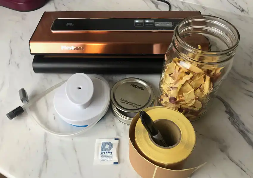 Showing the equipment to store the dehydrated apples using the method of mason jars and a vacuum sealer