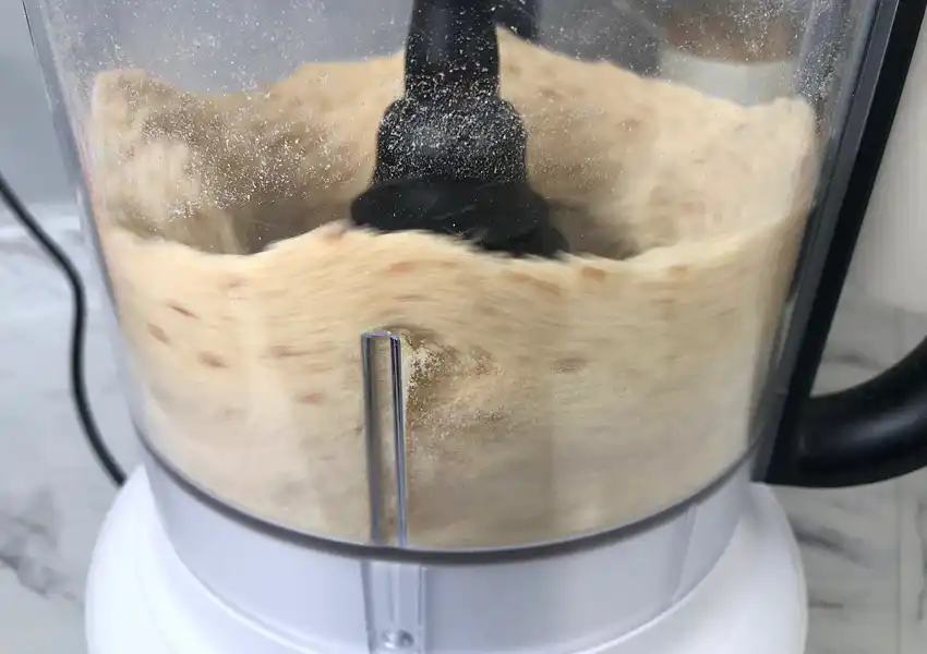 Showing dried bread slices being processed into crumbs on high speed