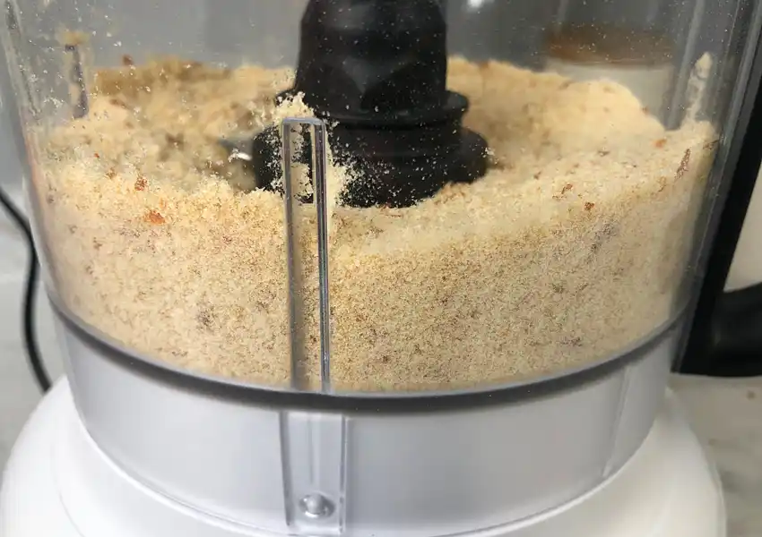 Close up showing a food processor after the dried bread slices were processed into fine crumbs