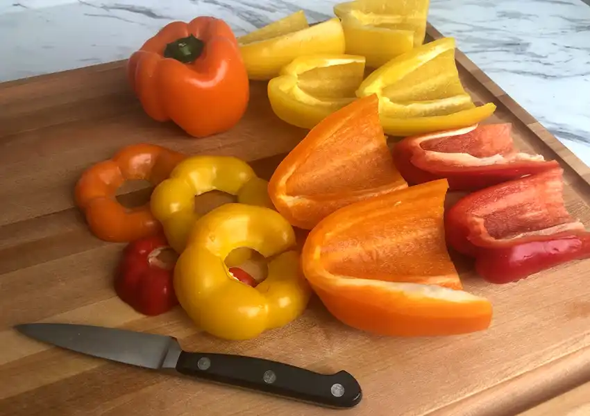 Showing bell peppers cleaned up with no stem and seeds removed