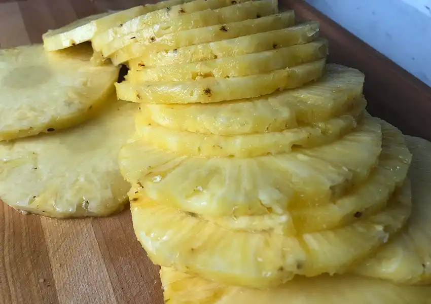 A photo showing the pineapple sliced up on a cutting board