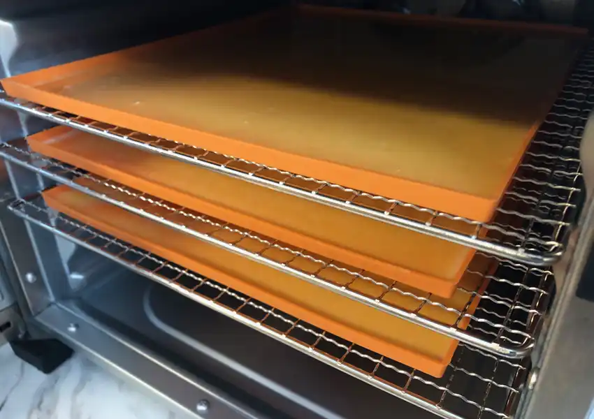 Showing the trays of liquid raw eggs in the dehydrator