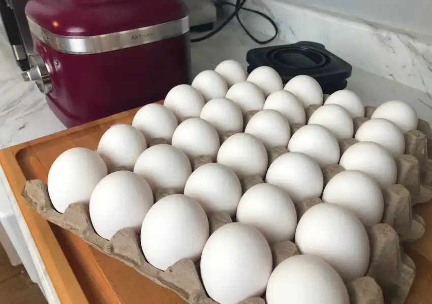 Showing a flat of eggs on the counter ready for cracking open