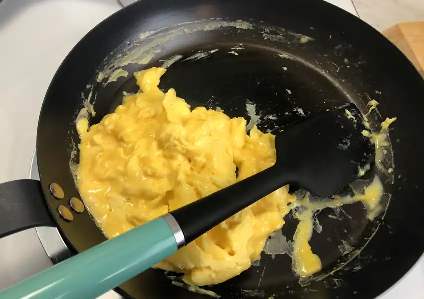 Showing the blended eggs starting to cook in the frypan