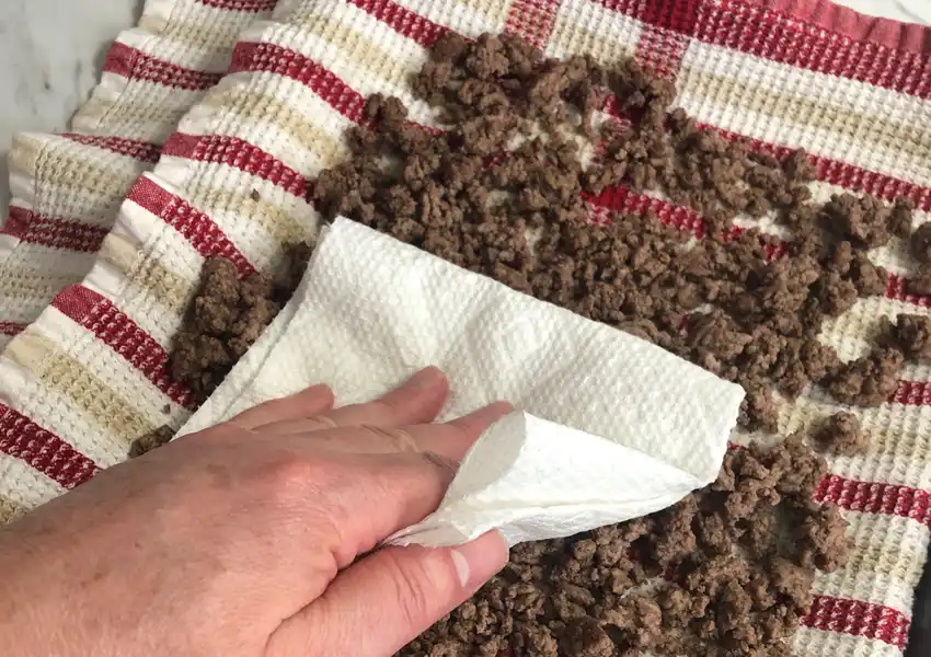 Patting the ground beef to get any excess grease and moisture out